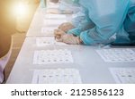Small photo of blur background of group doctors wearing anti-virus clothing testing coronavirus covid-19 on people by antigen test kits. Antigen Rapid Test Kit (ATK) for Covid 19, Omicron, Deltacron strains.