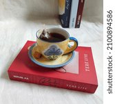 Small photo of central Sulawesi, Indonesia - Desember 17, 2021 : selective focus on a cup of tea with novel book by Tere Liye. Brightmood photography