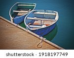 Two Old Rowboats Docked In...