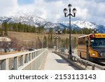 School bus and other vehicles drive on the bridge in Whitehorse, Yukon Territory, Canada