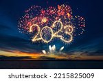 Happy New Year 2023. Beautiful creative holiday web banner or flyer with red fireworks and Golden sparkling number 2023 on blue sky  over sea