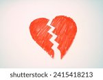 Hand holding broken heart on white background. Concept of broken heart.