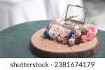 Small photo of A lavishly decorated box containing wedding rings as a wedding gift
