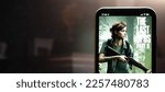 Small photo of On the smartphone screen, the computer game The Last of Us Part II. The Last of Us series. Russia, Moscow, January 2023