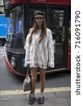Small photo of LONDON, ENGLAND - September 15, 2017 Estelle Pigault wearing a white knit, Chloe bag, slippers, socks, flat cap during London Fashion Week September 2017 outside Eudon Choi