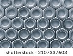 Small photo of Metal nuts in a row background. Chromed screw nuts. Steel nuts pattern. Tools for work.