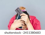 Small photo of Stressed woman falls victim to scammer tricked into stealing all her money online.