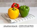 red yellow green sweet pepper on kitchen towel colorful paprika
