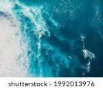 Blue ocean with waves and foam. Aerial view with surfer and sea background
