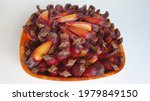 Small photo of Pinion, pine nuts in wooden bowl,on white background. Pinion, typical food of Brazilian June festival. Pinion, Araucaria seed. Top view.