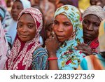 Small photo of Abuja Nigeria - February 26, 2023: Community Sensitization on Covid 19, Health and Water Hygiene. Africans sitting, queuing, and Waiting for Free Medical Outreach Care. Electoral Processes in Africa.