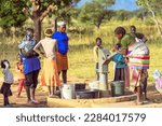 Small photo of Talata, Plateau State - April 2, 2023: Indigenous Africans Fetching Water from a Newly Built Indian Hand Pump. Community Members Fetching Water for Domestic Use.