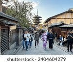 Small photo of Kyoto, Japan - 07.11.2023. Yasaka Pagoda view and Hokan-ji Temple from Yasaka Dori street in Kyoto, Japan. Popular touristic street leading to Kyomizu Dera, Ninenzaka and Sennenzaka. Traditional stree