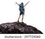 Hiker with backpack standing on top of the mountain with raised hands