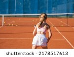 Teenage girl playing tennis and ...