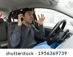 Small photo of Furious man gesticulates with hands stuck in traffic jam. Crazy driver yelling from car desperately. Stress, traffic rush hour, anxious, madness, rudeness concepts