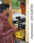 Small photo of Ooty, Tamilnadu, India- December 4, 2022: Person drinking tea at chamraj tea centre.It is an outlet of Chamraj tea factory located on the main road via ooty to coonoor