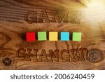 Small photo of Hand writing sign Game Changer. Concept meaning Sports Data Scorekeeper Gamestreams Live Scores Team Admins Building An Unfinished White Jigsaw Pattern Puzzle With Missing Last Piece