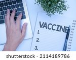 Small photo of Hand writing sign Vaccine. Business approach preparation of killed microorganisms or living attenuated organisms Office Supplies Over Desk With Keyboard And Glasses And Coffee Cup For Working