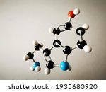 Small photo of Molecular model of a molecule of serotonin with degraded background