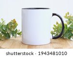 Blank black handle mug mockup photo with eucalyptus ,black rim mug on wood table