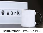 Blank black handle mug with work message led light box on black background. 11 oz mug mock up