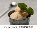 Small photo of Lemon sorbet with mint leaf, refreshing ice cream, serving in a tin bucket
