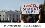 Small photo of A man holds an CANCEL STUDENT DEBT protest sign in front of the White House on a sunny summer day. Student debt was a hot topic during the COVID-19 pandemic.