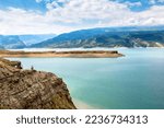 Sulak River in Dagestan, Russia. Scenic view of Chirkey Reservoir, sky and water. Mountain landscape with natural landmark of Dagestan in summer. Travel, sightseeing, tourism and nature of Caucasus. 