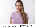 Small photo of Girl awkward hearing disturbing displeasing story details clenching teeth frowning grimacing aversion, reluctance, showing dislike shock, standing bothered wanna escape uncomfortable situation