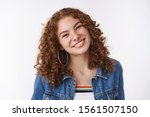 Small photo of Friendly charismatic happy curly-haired freckled young girl without makeup accepting flaws acne prone skin smiling carefree enjoying youth standing playful positive mood white background