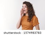 Cute armenian curly-haired girl yelling loud turn left hold palm open mouth calling brother come down dinner ready standing white background shouting searching friend crowded party