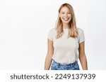 Portrait of happy smiling woman showing white smile, laughing and looking carefree at camera, standing over white background