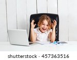 Young beautiful girl sitting at working place, laughing in office.