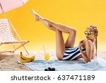 Luxury young woman on summer vacation and pleasant leisure time with drinks and braids in sunglasses. Taking sunbath and mango smoothie, Beauty concept.