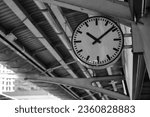 Small photo of The clock is the only constant in a subway station full of movement and change.