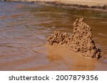 sand castle on the beach near the water. High quality photo