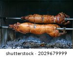 Pig roasted on a barbecue spit. ...