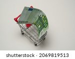 100 (hundred) euros for shopping, in a shopping cart on white background. High quality photo