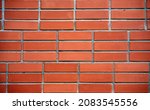 Fragment of red brick wall closeup. The structure of the background. Template for an inscription. Mockup for design. High quality photo