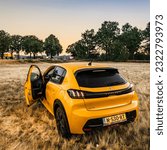 Small photo of Amsterdam, Netherlands, 01.06.2023: This intriguing photograph captures the rear view of the Peugeot 208 GT Line model from 2022 in Amsterdam. With the open door and window, it invites a glimpse into