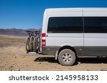 Small photo of 4x4 offroad van with hitch bike rack installed on the back. Off-road camper with bicycle rack. Travel, tourism concept. Healthy lifestyle, sport. Cycle tour concept.