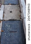 Small photo of Iron and cement gutter covers make the garden neater and safer for pedestrians