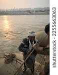 Small photo of Praygaraj,UP,01 14 2023:People fetching water from river Ganges on platoon bridge