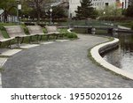Small photo of Swerving path with empty benches around a pond