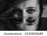 Small photo of Woman eyes closeup reflected in mirror. Hypnotize strong look. Hypnotic deeply penetrating glance. Revengeful insidious expectant gaze. Young caucasian girl face. Black and white portrait. Good vision