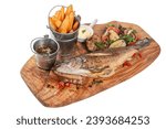 Small photo of Grilled whole sea bass with fried potato slices, grilled vegetables and sauces. Grilled spicy fish sea bass . Baked Sea Bass fish. Top view. Isolated on a white background