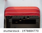 red curve awning of shop. red canvas roof.