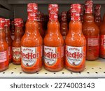 Small photo of Pearland, Texas, USA - March 10, 2022: Frank's Red Hot Original Cayenne Pepper Sauce 12 fl oz bottles on the shelf at a grocery store in Texas, USA.