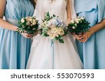 Wedding bride and your girlfriends in blue dress with bouquets